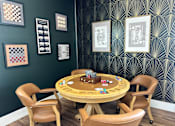 Thumbnail 15 of 24 - Game room with card table and wall art at Lofts at Innovation Center Apartments, Richland, WA