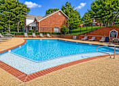 Thumbnail 1 of 14 - A pool surrounded by a brick border and lounge chairs.