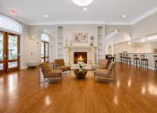 Thumbnail 8 of 13 - A living room with a fireplace and chairs.