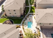 Thumbnail 7 of 31 - an aerial view of a neighborhood of houses with a swimming pool