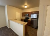 Thumbnail 2 of 31 - a kitchen with an island and stainless steel appliances