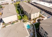 Thumbnail 6 of 31 - an aerial view of a neighborhood with houses and a swimming pool