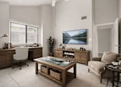 Thumbnail 10 of 11 - A room with a desk, chair, and a large painting on the wall.