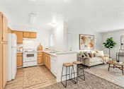 Thumbnail 7 of 11 - A modern kitchen with a white refrigerator and wooden cabinets.