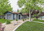 Thumbnail 2 of 11 - A blue house with a grey roof and a white fence.