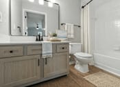 Thumbnail 31 of 31 - A bathroom with a white toilet, a white bathtub, and a white sink. at Waterbridge Apartments , Florida, 32837