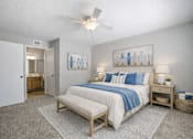 Thumbnail 26 of 31 - A bedroom with a bed, nightstands, and a ceiling fan. at Waterbridge Apartments , Orlando, 32837