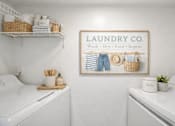 Thumbnail 18 of 31 - A laundry room with a sign that says Laundry Co. at Waterbridge Apartments , Florida, 32837