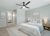 Thumbnail 27 of 31 - A bedroom with a bed, nightstands, and a ceiling fan. at Waterbridge Apartments , Orlando