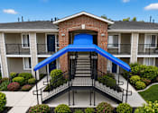 Thumbnail 8 of 28 - A blue awning is attached to a brick building.