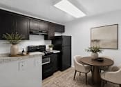 Thumbnail 22 of 28 - A kitchen with black cabinets and a black refrigerator.