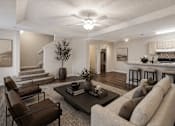 Thumbnail 10 of 12 - A living room with a couch, chairs, and a coffee table.