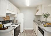 Thumbnail 12 of 12 - A kitchen with white cabinets and a black stove top.