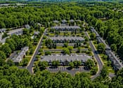 Thumbnail 4 of 12 - A bird's eye view of a residential area with houses and trees.