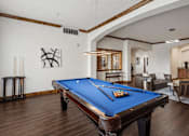 Thumbnail 5 of 17 - A pool table is in the middle of a room with a blue cloth.