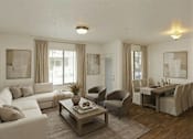 Thumbnail 13 of 17 - A living room with a white sofa, a grey armchair, and a wooden coffee table.