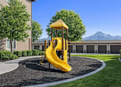 Thumbnail 11 of 17 - A yellow playground slide in the middle of a gravel area.