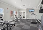 Thumbnail 6 of 21 - Fitness center with cardio and strength equipment at Stetson Meadows Apartments, Colorado Springs, 80922