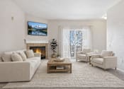 Thumbnail 11 of 21 - Living room with fireplace and balcony access at Stetson Meadows Apartments, Colorado Springs, 80922