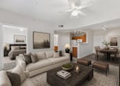 Thumbnail 13 of 21 - A modern living room with a large couch and a coffee table.