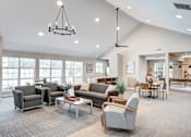Thumbnail 3 of 20 - A spacious living room with a variety of seating options and a large window.