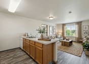 Thumbnail 20 of 24 - A kitchen with wooden cabinets and a white countertop.