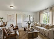 Thumbnail 16 of 24 - A living room with a brown leather chair and a white couch.