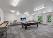 Thumbnail 10 of 24 - A room with a pool table, a billiard table, and a TV.