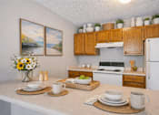 Thumbnail 10 of 14 - A kitchen with a white countertop and wooden cabinets.