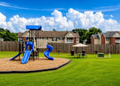 Thumbnail 5 of 12 - A playground with a blue slide and a brown and tan slide.