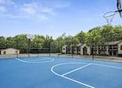 Thumbnail 4 of 18 - Outdoor basketball court with blue surface at Davidson Homes Apartments, Concord, North Carolina