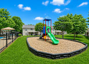 Thumbnail 9 of 20 - A playground with a green slide and a red and blue structure.