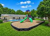 Thumbnail 10 of 20 - A playground with a green slide and a blue and red tower.