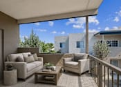 Thumbnail 15 of 16 - Covered balcony with outdoor seating and sky views at Vista Linda Apartments, Santa Fe, 87507