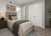 Thumbnail 13 of 16 - Cozy bedroom with upholstered headboard and closet at Vista Linda Apartments, Santa Fe, New Mexico