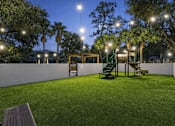 Thumbnail 10 of 28 - A park with a bench and a playground. at Epic Apartments , Daytona Beach, Florida