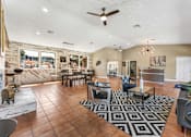 Thumbnail 21 of 28 - A living room with a black and white rug and brown tiled flooring. at Epic Apartments , Daytona Beach, 32114