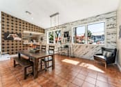 Thumbnail 17 of 28 - A dining room with a wooden table and chairs. at Epic Apartments , Florida, 32114