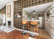 Thumbnail 16 of 28 - A kitchen with a bar stool and a fridge. at Epic Apartments , Daytona Beach
