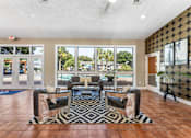 Thumbnail 22 of 28 - A living room with a black and white patterned rug in front of a glass door. at Epic Apartments , Daytona Beach