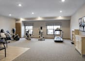 Thumbnail 34 of 37 - Fitness center with cardio and strength equipment at The Estates at Arbor Oaks Apartments, Minnesota