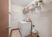 Thumbnail 10 of 37 - Laundry room with wire shelving and storage at The Estates at Arbor Oaks Apartments, Andover, 55304