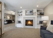 Thumbnail 23 of 37 - Living room with built in fireplace and shelving at The Estates at Arbor Oaks Apartments, Andover, Minnesota