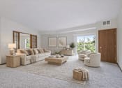 Thumbnail 2 of 37 - Living room with sliding doors and balcony access at The Estates at Arbor Oaks Apartments, Andover