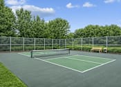 Thumbnail 33 of 37 - Tennis court with net and surrounding fencing at The Estates at Arbor Oaks Apartments, Minnesota, 55304
