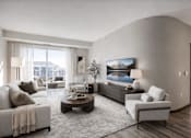 Thumbnail 15 of 24 - A modern living room with a large couch, a coffee table, and a TV mounted on the wall.