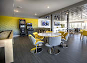 Thumbnail 10 of 26 - Community lounge with game area and seating at Hello Apartments, Minneapolis
