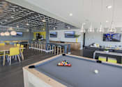 Thumbnail 14 of 26 - Community clubhouse with pool table and lounge seating at Hello Apartments, Minnesota