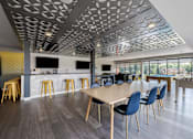 Thumbnail 8 of 26 - Modern coworking space with dining and kitchen area at Hello Apartments, Minneapolis, Minnesota