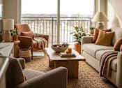 Thumbnail 17 of 26 - Bright living room with warm tones and balcony view at Hello Apartments, Minneapolis, Minnesota
